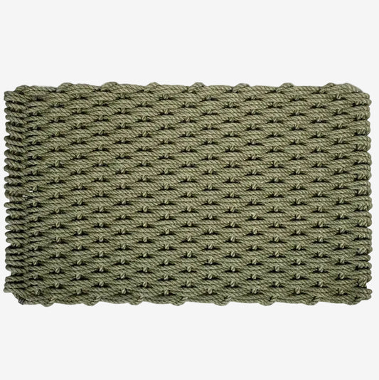 Loden green handwoven rope doormat with a tight, textured weave and braided edges.