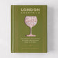 Green hardcover "London Cocktails" recipe book with a map-filled cocktail glass design.