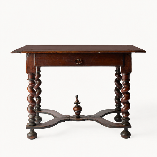 Louis XIII oak desk with barley-twist legs, single drawer, brass pull, and decorative cross support on white background.