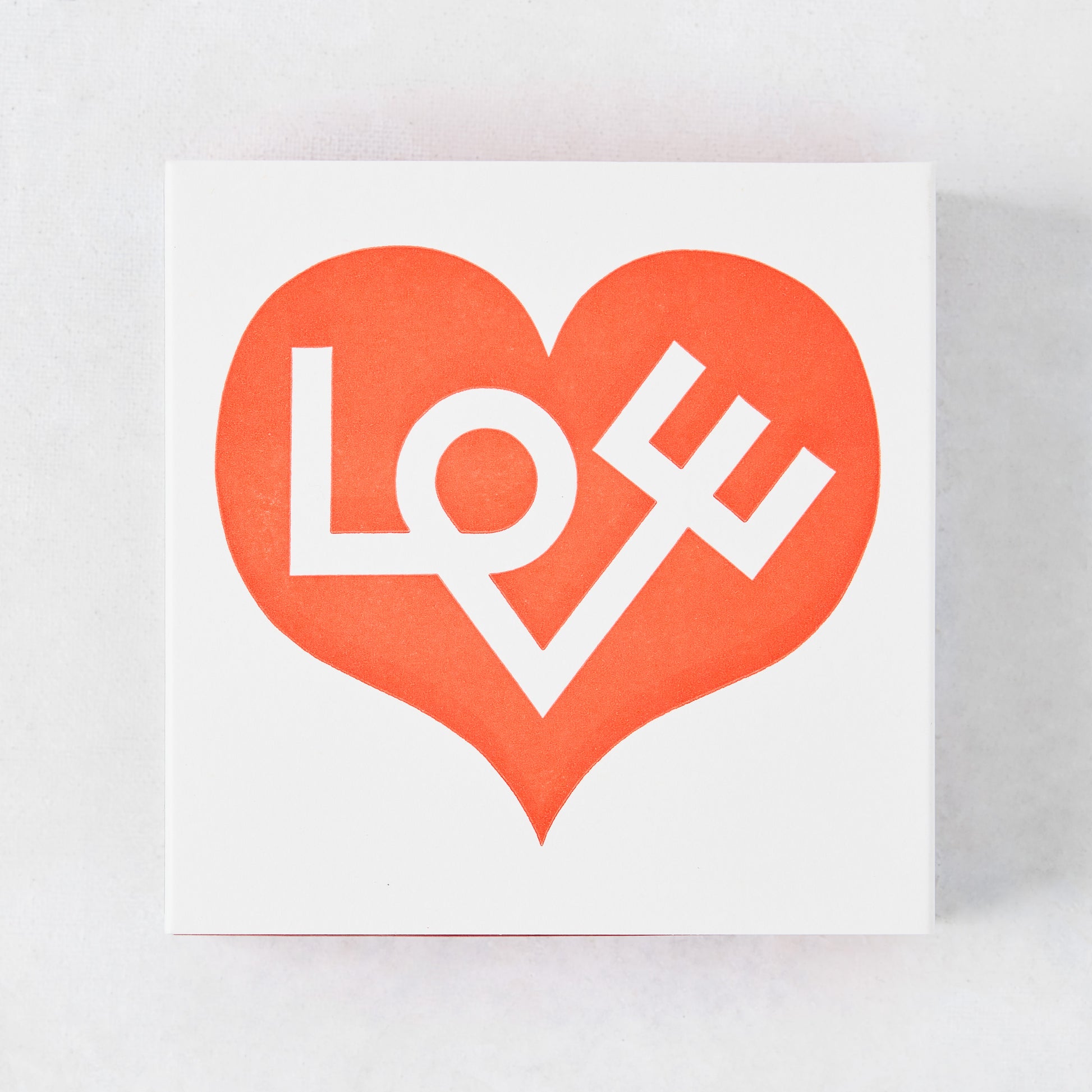 White matchbox with a large red heart design and "LOVE" text.