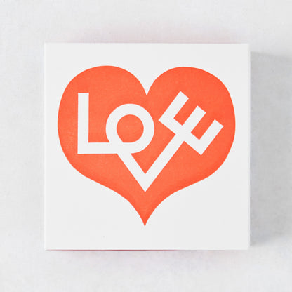 White matchbox with a large red heart design and "LOVE" text.
