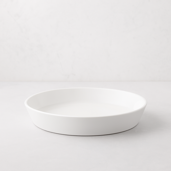 White, round Luce Small Ceramic Serving Dish, 11.5" diameter, with a minimalistic design.