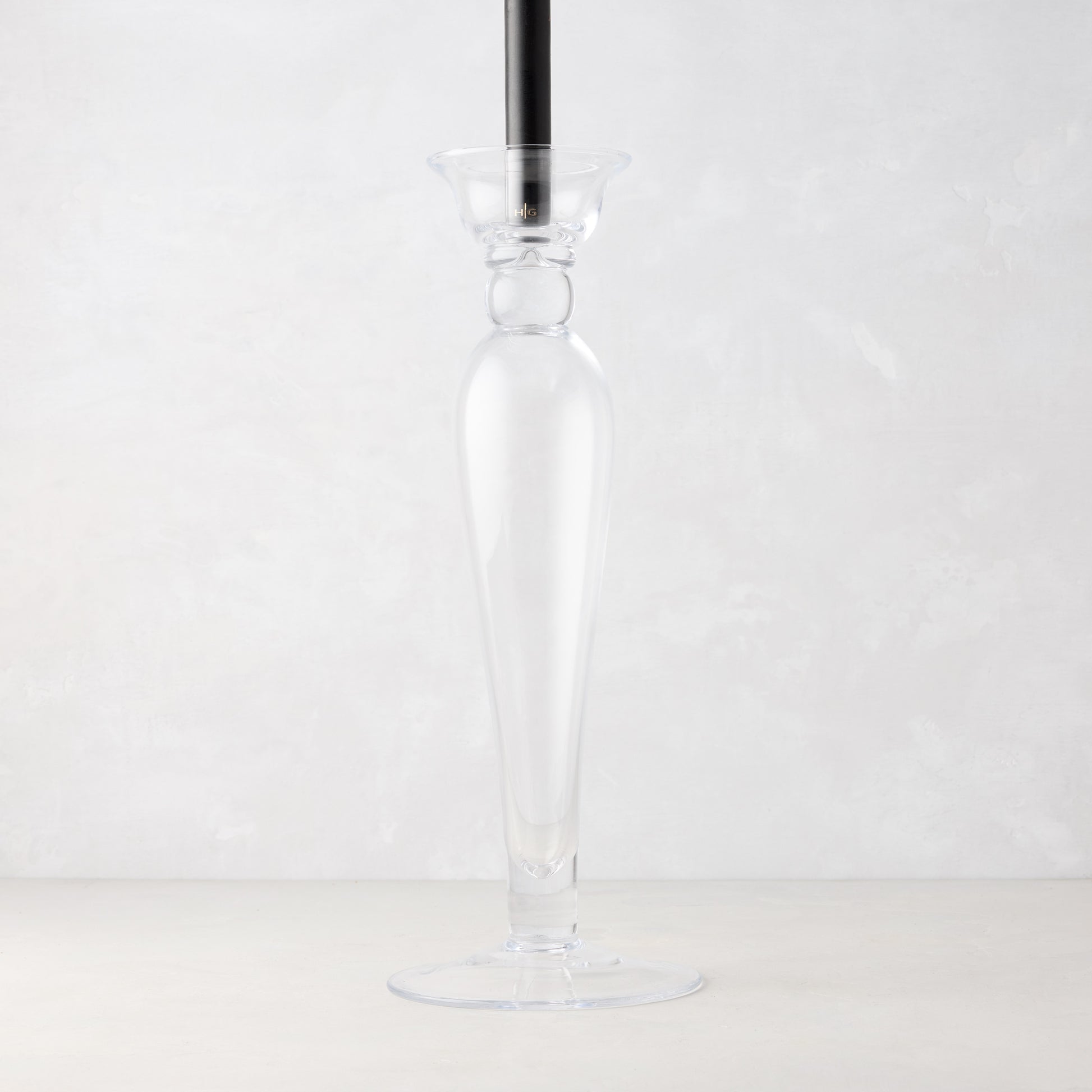 Lumière Glass Single Candlestick, 16"H, clear glass with a black taper candle.