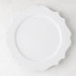 White 11" Lungarno ceramic dinner plate with sculptural, scalloped edges.