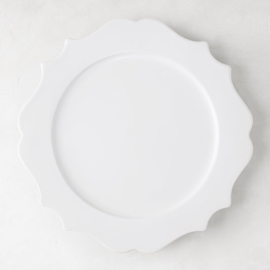 White 11" Lungarno ceramic dinner plate with sculptural, scalloped edges.
