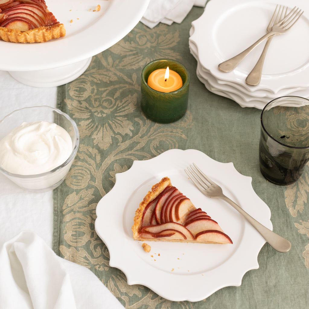 White ceramic Lungarno salad/dessert plate with sculptural rim, holding a slice of pear tart.