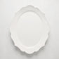 White ceramic Lungarno serving platter with sculptural, scalloped edges.