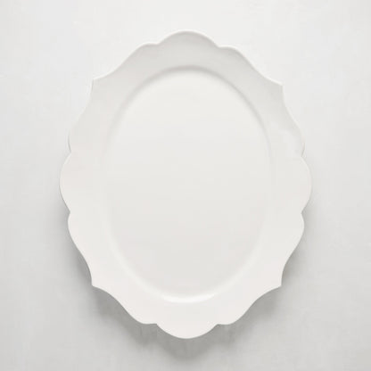 White ceramic Lungarno serving platter with sculptural, scalloped edges.