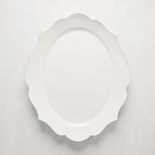 White ceramic Lungarno serving platter with sculptural, scalloped edges.
