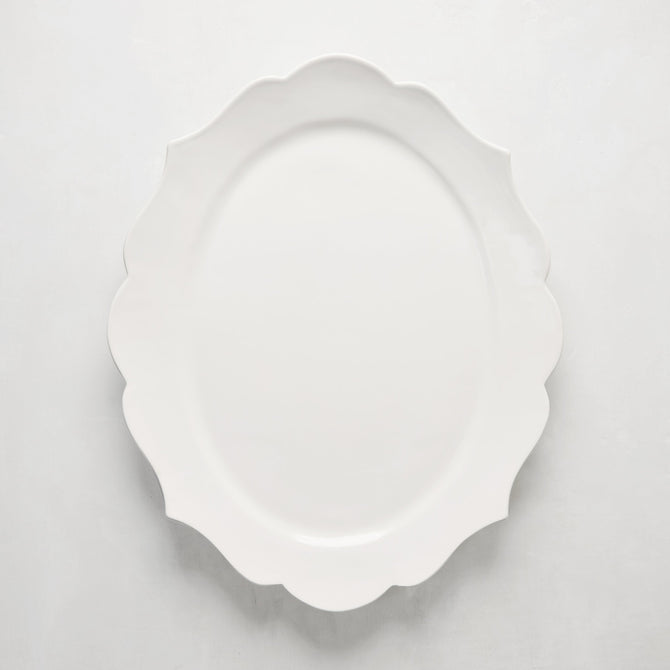 White ceramic Lungarno serving platter with sculptural, scalloped edges.
