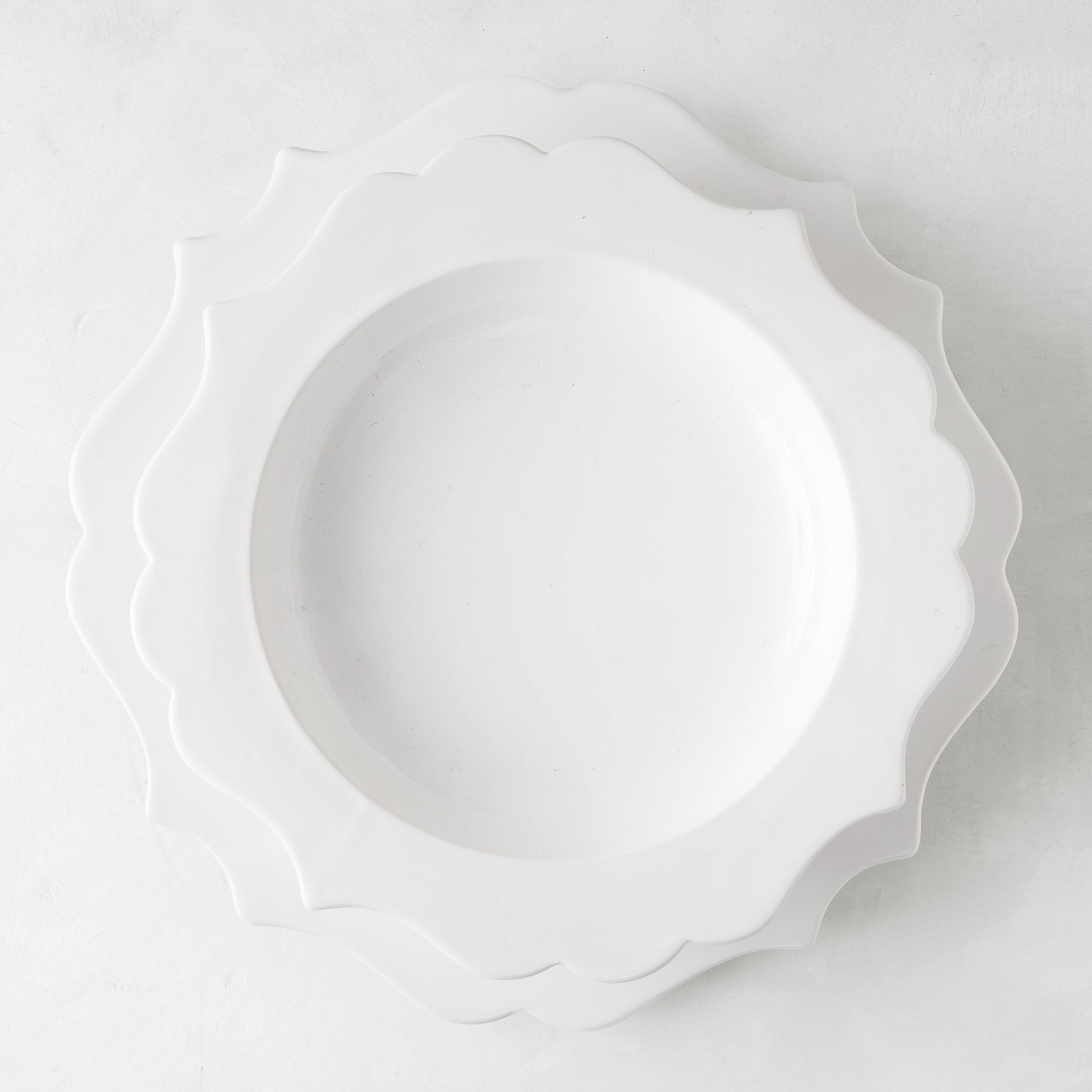 White ceramic Lungarno soup bowl with sculptural, scalloped edges, 9.5" diameter.