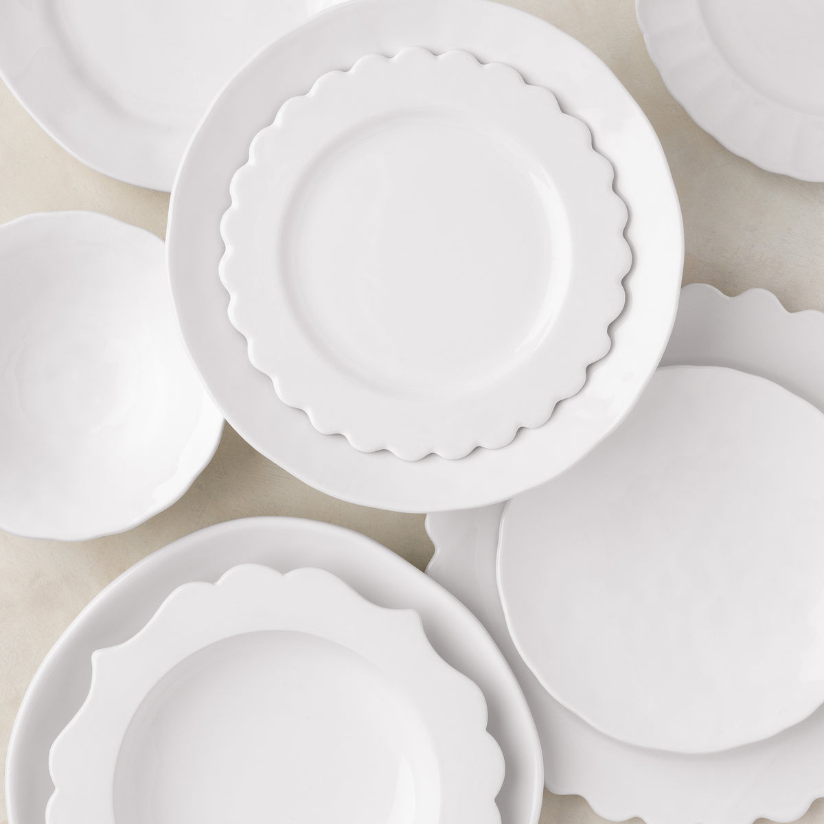 White ceramic Lungarno soup bowl with scalloped edge, 9.5" diameter, shown with matching dinnerware.
