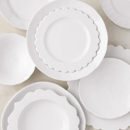 White ceramic Lungarno soup bowl with scalloped edge, 9.5" diameter, shown with matching dinnerware.