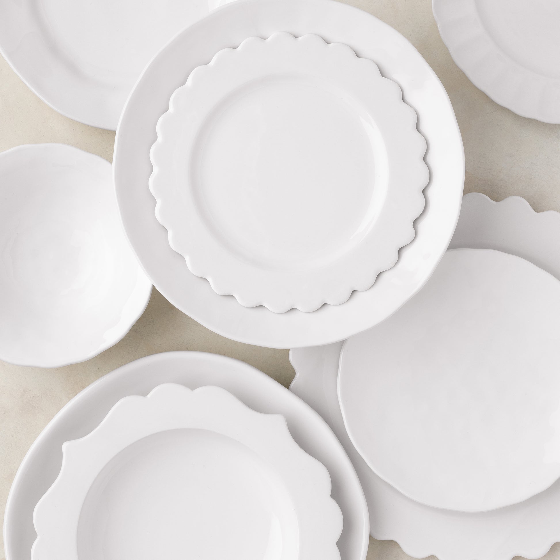 White ceramic Lungarno soup bowl with scalloped edge, 9.5" diameter, shown with matching dinnerware.