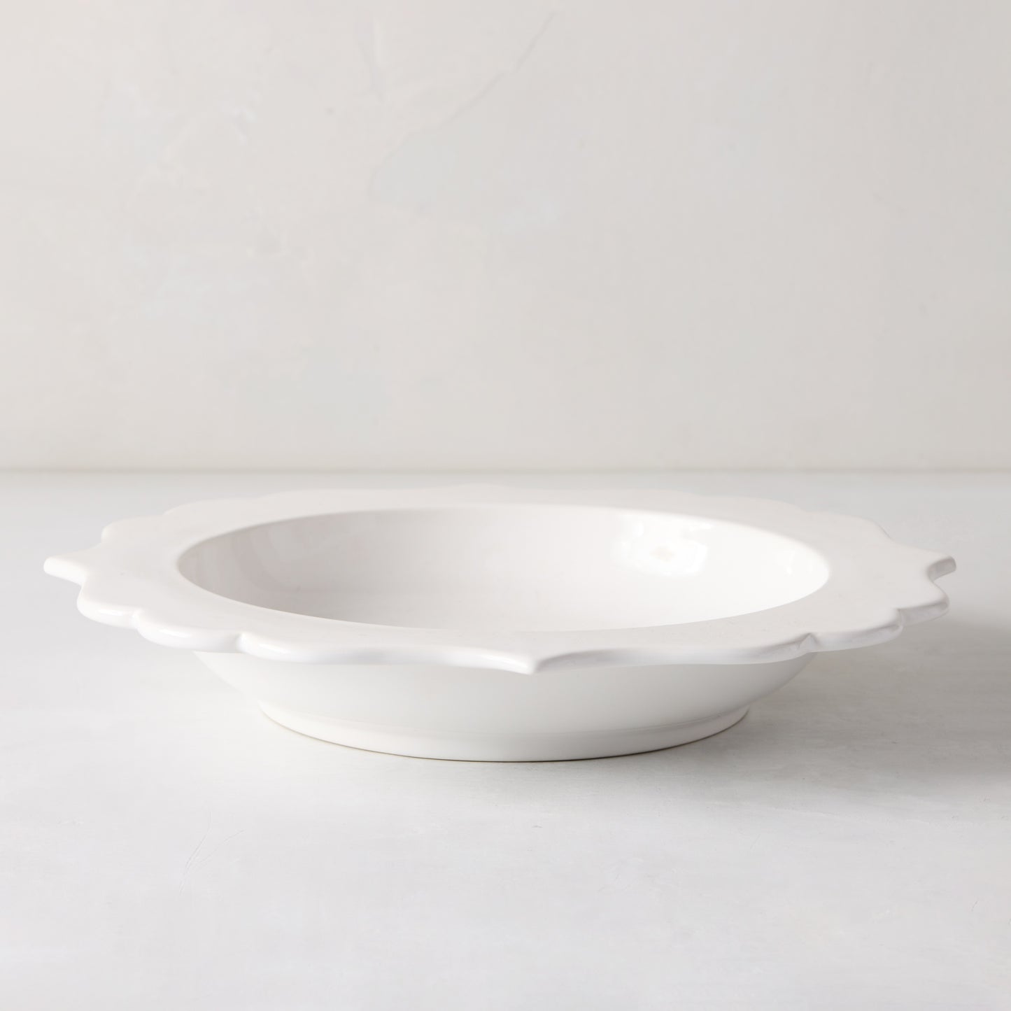 White ceramic Lungarno soup bowl with sculptural, scalloped rim.