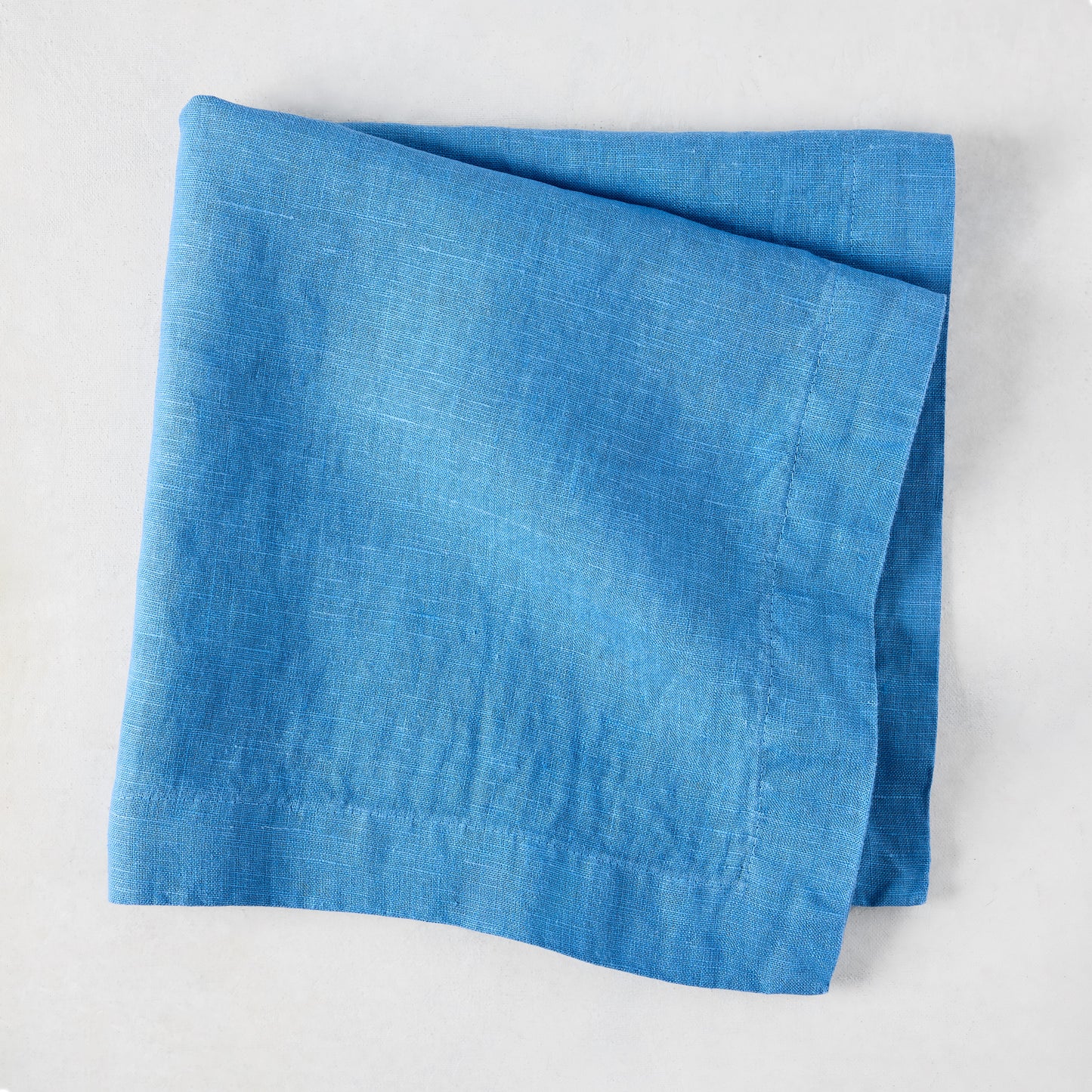 Lupine Blue HG Signature hand-dyed linen napkin, folded, 22-inch square.