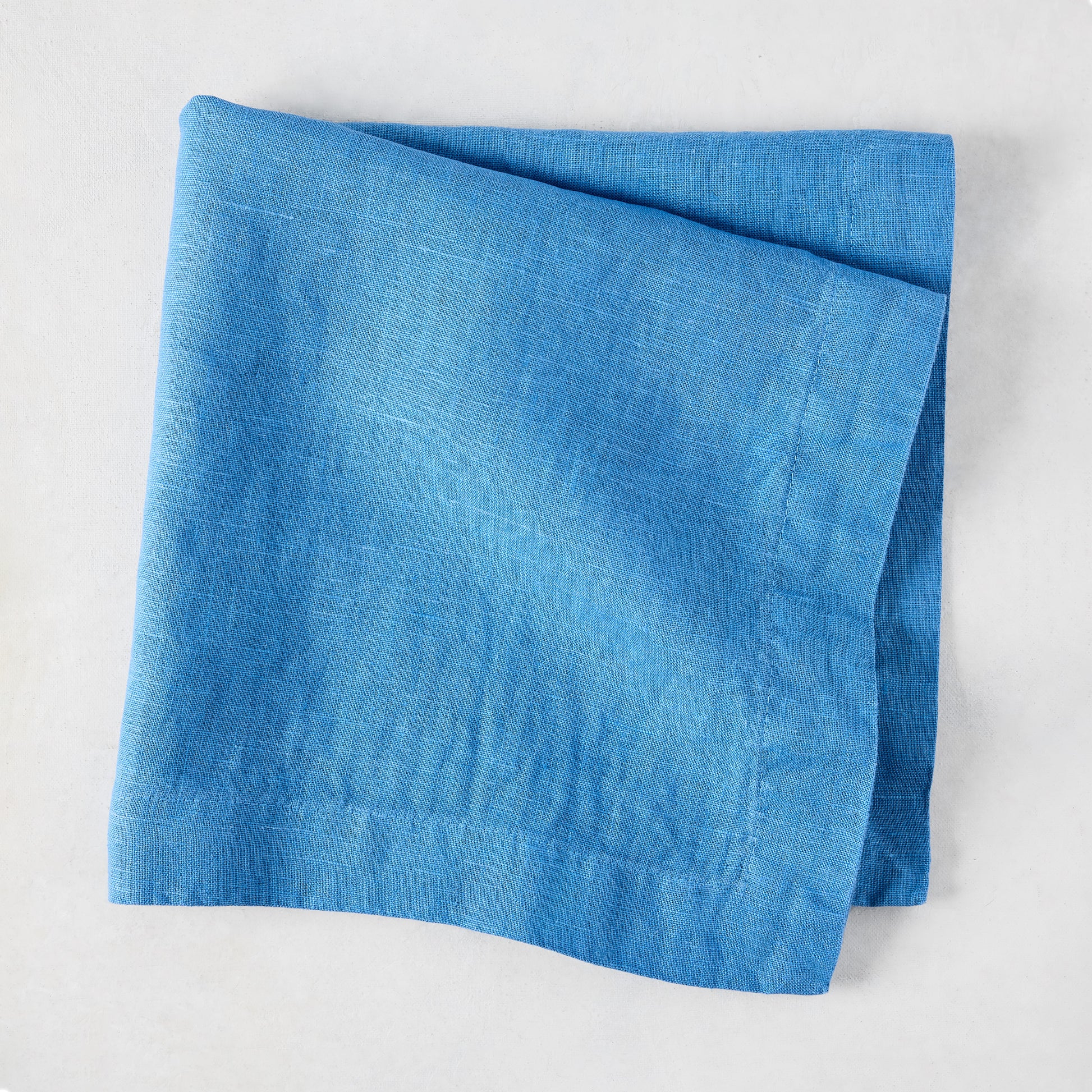 Lupine Blue HG Signature hand-dyed linen napkin, folded, 22-inch square.