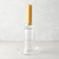 Large Luz clear glass candleholder with a lit amber pillar candle.