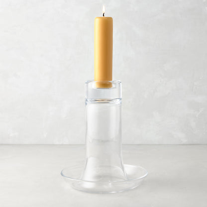 Large Luz clear glass candleholder with a lit amber pillar candle.