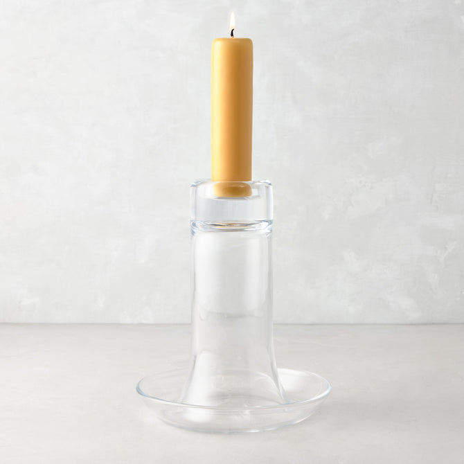 Large Luz clear glass candleholder with a lit amber pillar candle.