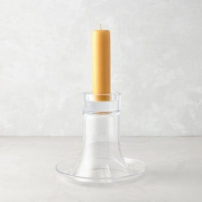 Medium Luz Candleholder, clear mouth-blown glass, with a tall amber pillar candle.