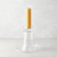 Medium Luz clear glass candleholder with a lit amber pillar candle.