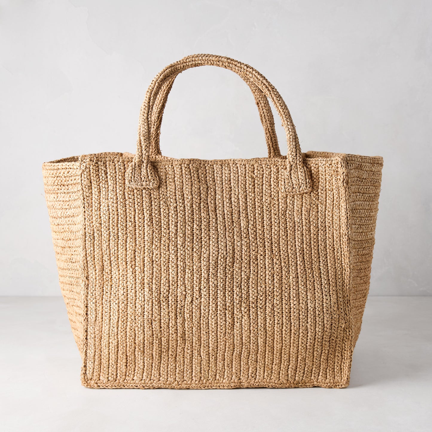 Madagascar Packable Raffia Tote Bag, natural tea-dyed, crocheted, with two top handles.