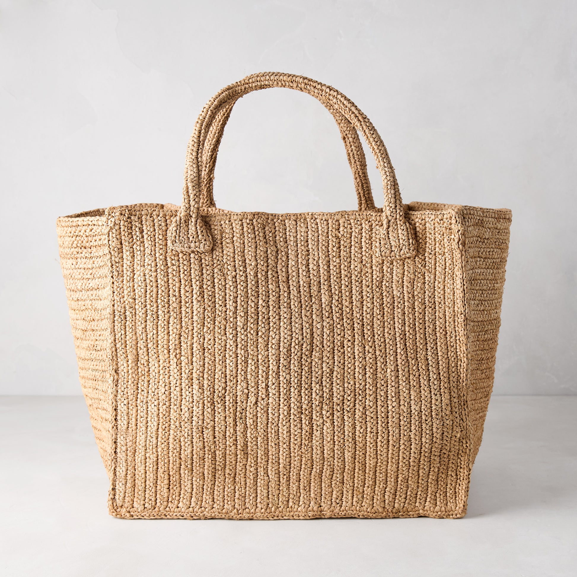 Madagascar Packable Raffia Tote Bag, natural tea-dyed, crocheted, with two top handles.