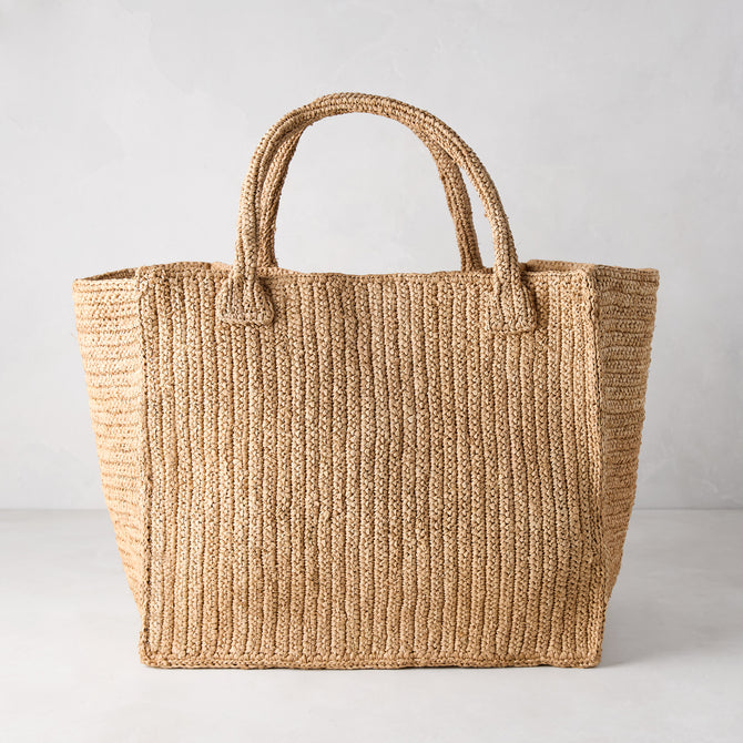 Madagascar Packable Raffia Tote Bag, natural tea-dyed, crocheted, with two top handles.
