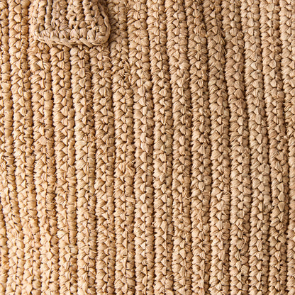 Close-up of a Madagascar Packable Raffia Tote Bag, showing its natural, tea-dyed crocheted raffia texture.