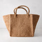 Madagascar Packable Raffia Tote Bag, natural tea-dyed crocheted raffia, wide rectangular shape with two handles.