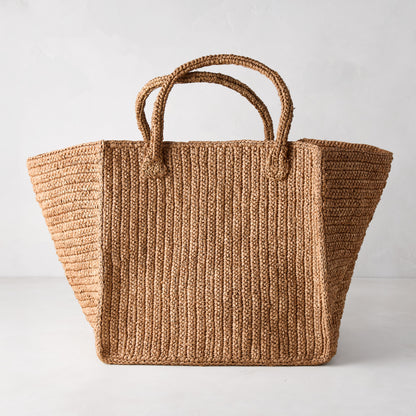 Madagascar Packable Raffia Tote Bag, natural tea-dyed crocheted raffia, wide rectangular shape with two handles.