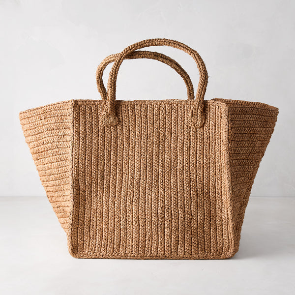 Madagascar Packable Raffia Tote Bag, natural tea-dyed crocheted raffia, wide rectangular shape with two handles.