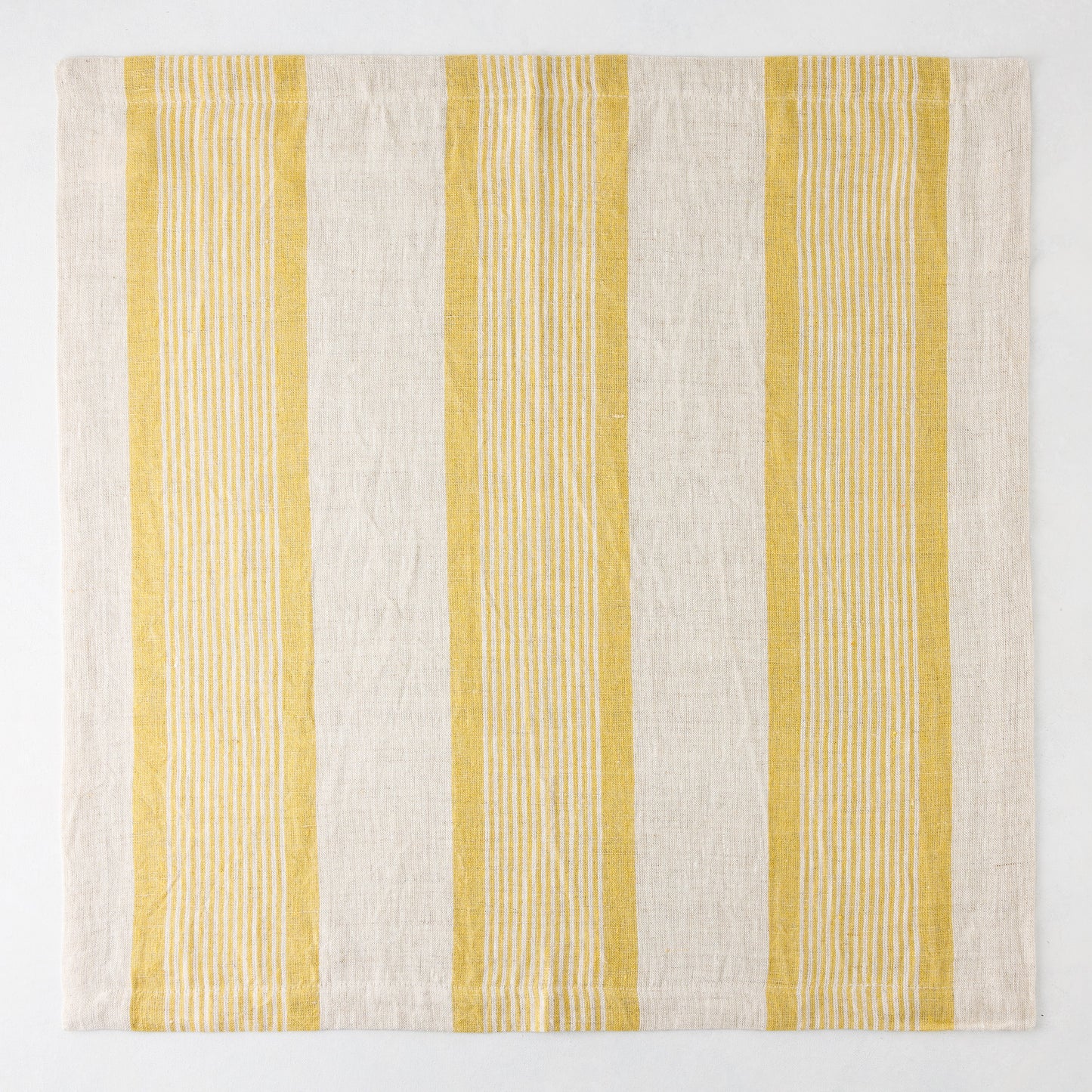 Madras Marigold and Natural Stripe Cotton Napkin, 22" square, with yellow stripes on a beige base.