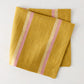 Madras Marigold, Oyster, and Pink Stripe Napkin, 100% washed cotton, 22" square.