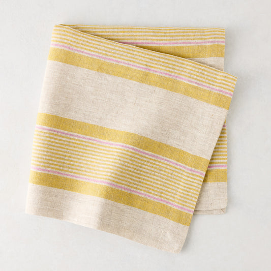 Folded Madras Marigold, Pink, and Natural Stripe Cotton Napkin, 22" square.