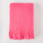 Magenta pink solid mohair throw, 72"L x 51"W, with fringed edges.