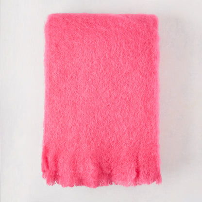 Magenta pink solid mohair throw, 72"L x 51"W, with fringed edges.