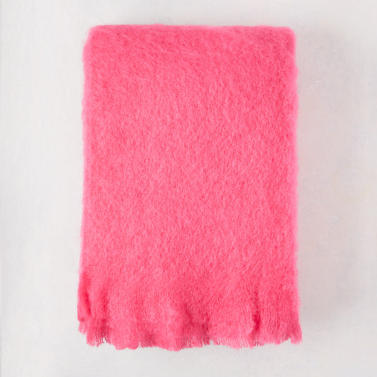 Magenta pink solid mohair throw, 72"L x 51"W, with fringed edges.