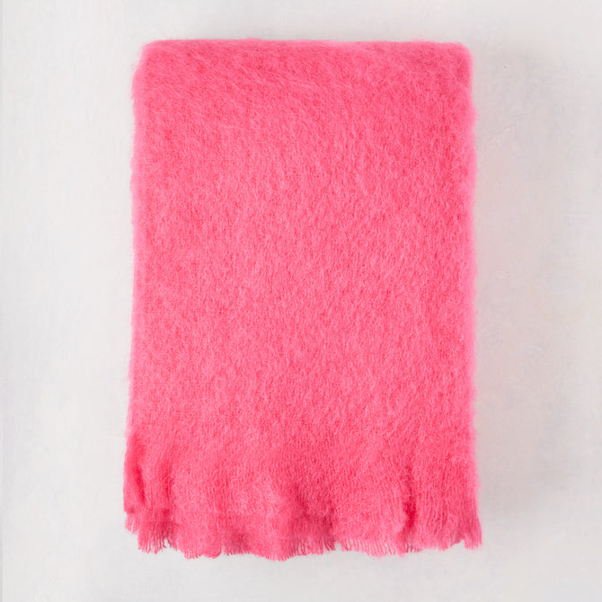 Magenta pink solid mohair throw, 72"L x 51"W, with fringed edges.