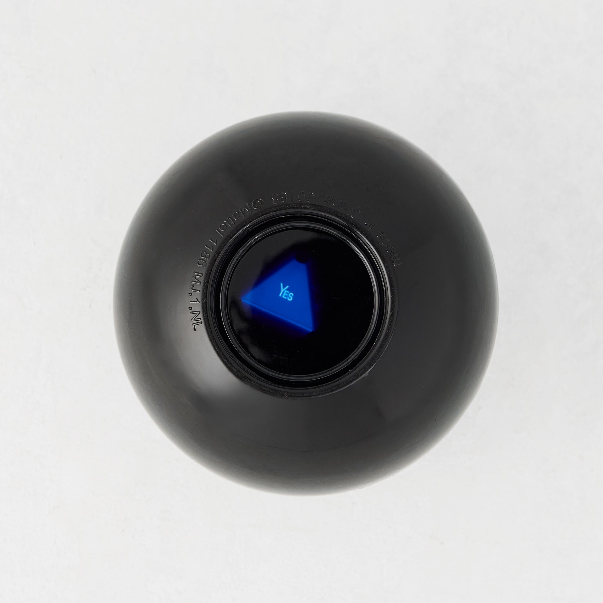 4.5-inch black Magic 8-Ball toy with a blue triangular window displaying the word Yes on a white background.
