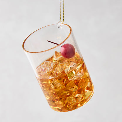 3.25-inch glass Manhattan cocktail Christmas ornament with amber liquid, ice cubes, and a red cherry garnish.