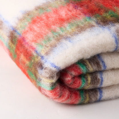 Handwoven Mantas Ezcaray mohair throw in a multicolored festive plaid pattern of yellow, blue, red, green, white, and brown.