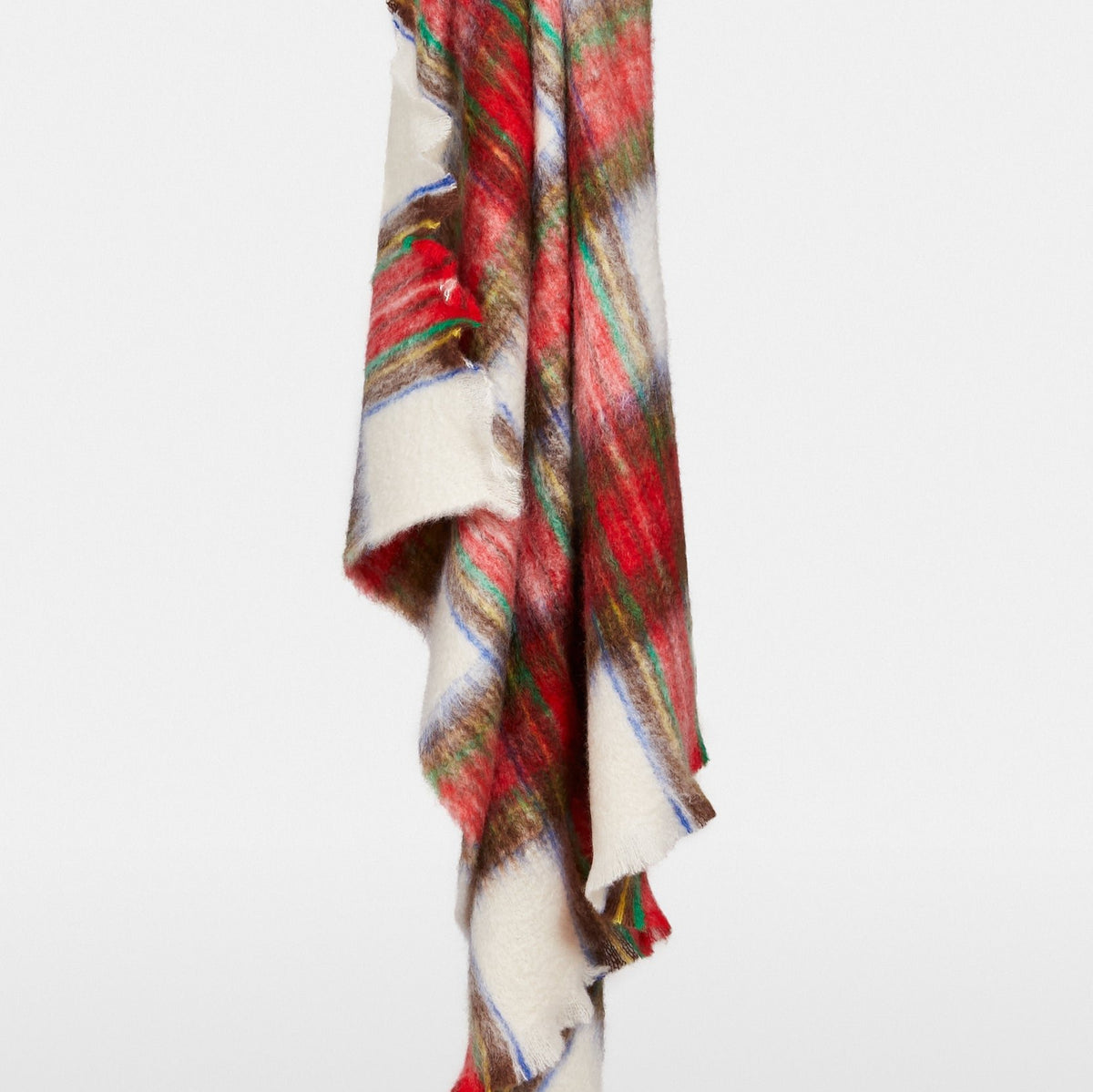 Handwoven Mantas Ezcaray mohair throw in a festive multicolored plaid pattern of red, yellow, green, and blue.
