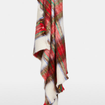 Handwoven Mantas Ezcaray mohair throw in a festive multicolored plaid pattern of red, yellow, green, and blue.
