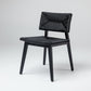 Black dining chair with woven rattan seat and back, dark wood frame.
