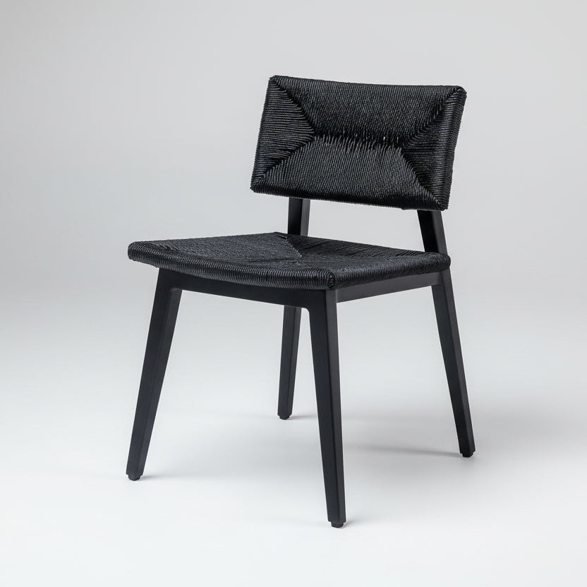 Black dining chair with woven rattan seat and back, dark wood frame.