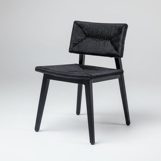 Black dining chair with woven rattan seat and back, dark wood frame.
