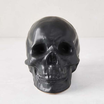 Matte black ceramic Halloween skull, 5.5”H x 7”W, with realistic features.