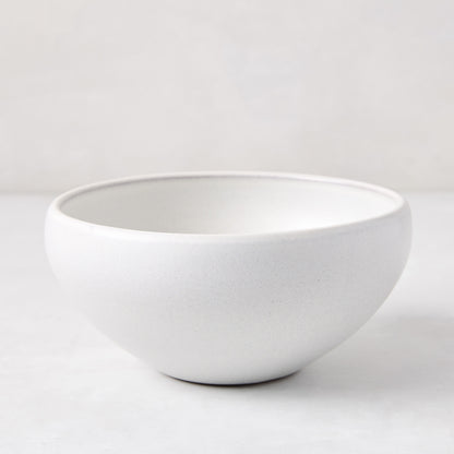 Matte white stoneware bowl with subtle grey speckles, handcrafted in Portugal.
